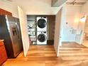 Convenient laundry closet including washer, dryer, and shelving for storage at 10 N Summerlin Ave # 25, Orlando, FL 32801