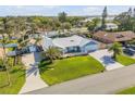 Wide aerial view of a single-story home with metal roof, lush lawn, and mature landscaping at 120 Sand Dunes Dr, Ormond Beach, FL 32176