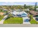 High aerial view of a single-story home with lush lawn and tropical landscaping at 120 Sand Dunes Dr, Ormond Beach, FL 32176