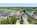 An aerial view of homes backing onto a golf course showcasing the community layout at 1539 Corolla Ct, Reunion, FL 34747