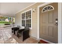 Welcoming front porch with seating area, perfect for enjoying quiet moments by the front door at 1563 Dess Dr, Orlando, FL 32818