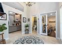 Lovely foyer with an attractive view into the Gathering room with its floor-to-ceiling fireplace and a view to the play room at 1682 Wingspan Way, Winter Springs, FL 32708