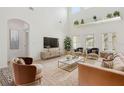 Bright living room with high ceilings, neutral decor, and modern furnishings at 1825 Saffron Plum Ln, Orlando, FL 32828