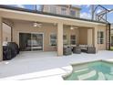 Covered patio with comfortable seating near a pool, perfect for outdoor living at 1825 Saffron Plum Ln, Orlando, FL 32828