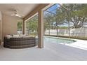 Screened outdoor pool area with comfortable seating and a ceiling fan at 1825 Saffron Plum Ln, Orlando, FL 32828
