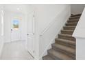 Hallway view features the front door, stairway, and coat closet at 1912 Archer Dr, Minneola, FL 34715