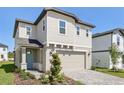 Charming two-story home with a paved driveway, attached two-car garage, and inviting blue front door at 2236 Hen Rd, Minneola, FL 34715