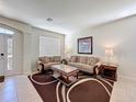 Cozy living room with tile flooring, sofas, stylish tables, and natural light at 2530 Holtrock St, Kissimmee, FL 34747