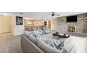 Open concept living area with brick fireplace, adjacent to a bar and dining area for easy entertaining at 25548 Pine Valley Dr, Mount Plymouth, FL 32776