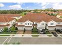 An aerial view of a townhouse community with red tile roofs and lush green landscaping at 2710 Bolzano Dr, Apopka, FL 32712