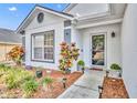 Close-up showcasing front door and walkway with manicured garden and mulch at 280 Bay St, Apopka, FL 32712