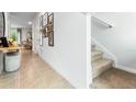 A tiled entryway featuring neutral walls, carpeted stairs, and a dining room visible in the background at 2907 Canary Ave, Davenport, FL 33837