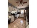Traditional kitchen with white cabinets, stainless steel appliances, and tile flooring at 3219 Chariot Pl, Orlando, FL 32818