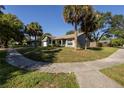 Charming home with mature trees, a cozy front porch, and a well-maintained lawn at 3220 Cardigan Ct, Orlando, FL 32812