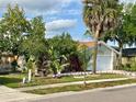 Landscaped front yard with lush greenery and decorative features enhancing curb appeal of this well-maintained home at 329 Kantor Blvd, Casselberry, FL 32707
