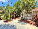 Beautifully landscaped front yard with a stone exterior and lush, mature trees and greenery at 329 Kantor Blvd, Casselberry, FL 32707