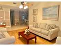 Cozy living room featuring hardwood floors, comfortable seating, and a view to the dining area at 329 Kantor Blvd, Casselberry, FL 32707
