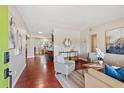 Inviting living room with hardwood floors, stylish furnishings, and an open layout to the dining and kitchen at 3425 N Westmoreland Dr, Orlando, FL 32804