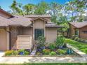 Charming home features a well-manicured lawn and garden, creating a welcoming curb appeal at 419 Newton Pl, Longwood, FL 32779
