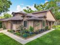 Attractive exterior view of a well-maintained home with a lush green lawn and colorful flowerbeds at 419 Newton Pl, Longwood, FL 32779
