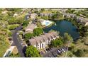 Beautiful aerial view of community with a pool, lush landscaping, and serene lake at 4708 Walden Cir # 37, Orlando, FL 32811