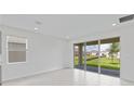 Bright living room with neutral walls, large sliding glass doors, and lots of natural light at 503 Silver Palm Dr, Haines City, FL 33844