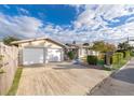 Tan exterior showcasing a well-kept home with an attached garage and manicured landscaping at 509 Eastwood Ln, Daytona Beach, FL 32118
