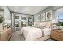 Serene primary bedroom showcasing soft colors, a large window, and decorative wall art at 557 Moon Shell Cir, New Smyrna Beach, FL 32168