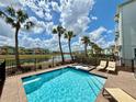 Resort-style pool and spa with palm trees and picturesque lake views at 7968 Shaker St, Kissimmee, FL 34747