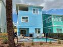A two-story vacation home featuring a private pool, spa, and outdoor dining area at 7968 Shaker St, Kissimmee, FL 34747