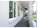 Close-up view of the front porch with textured walls and decorative stone pillars at 854 Escabar Dr, Altamonte Springs, FL 32714