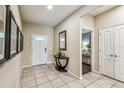 Bright foyer with neutral tile flooring, decorative accents, and a view into an adjacent bedroom at 8808 Macapa Dr, Kissimmee, FL 34747