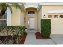 Close up of the front door with decorative plants and mulch landscaping at 9723 Pecky Cypress Way, Orlando, FL 32836