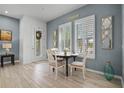 Bright dining area with modern light fixtures and beautiful natural light, set with round table and seating at 1010 Lychee Ct, Lake Mary, FL 32746