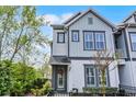 Attractive two-story townhome with gray and white exterior, well-maintained landscaping, and inviting entrance at 1010 Lychee Ct, Lake Mary, FL 32746
