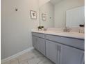 Bathroom with a double sink vanity, framed art and modern fixtures at 1036 Leader Street, Davenport, FL 33896