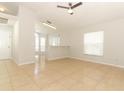 Spacious living room with tile flooring, a ceiling fan, and ample natural light at 1040 Hamlet Dr, Maitland, FL 32751