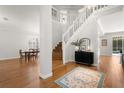 Inviting foyer with wood floors, staircase, and stylish console table at 1128 Brantley Estates Dr, Altamonte Springs, FL 32714