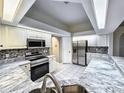 Bright kitchen with stainless steel appliances, granite countertops, and white cabinetry at 1200 Montheath Cir, Ocoee, FL 34761