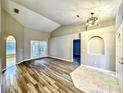 Open living area with modern lighting, vaulted ceiling, and wood-look flooring at 1200 Montheath Cir, Ocoee, FL 34761