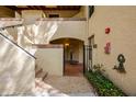 A condo entrance with stairs leading up to the front door that is behind an iron gate at 1270 Saint Tropez Cir # Ge, Orlando, FL 32806