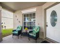 Inviting front porch with seating area, perfect for enjoying a morning coffee or relaxing in the evening at 13208 Canna Lily Dr, Orlando, FL 32824