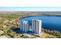 Scenic aerial shot showcases condo buildings overlooking a tranquil lake and landscaped grounds at 13427 Blue Heron Beach Dr # 1205, Orlando, FL 32821