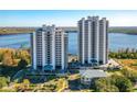 Close aerial view of condo buildings with manicured landscaping and ample parking at 13427 Blue Heron Beach Dr # 1205, Orlando, FL 32821