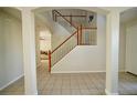 Bright foyer with wood and white staircase and views to the living room at 13520 Meadow Bay Loop, Orlando, FL 32824