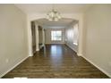 Open-concept living room with wood floors and view into the entry foyer at 13520 Meadow Bay Loop, Orlando, FL 32824