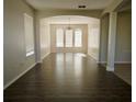 Open-concept living room with wood floors and view into the dining room at 13520 Meadow Bay Loop, Orlando, FL 32824