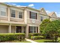 Inviting exterior of a two-story townhome with manicured landscaping and a charming front entrance at 1530 Tally Cir, Oviedo, FL 32765