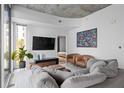 Bright living room boasts large windows, city views, and stylish furnishings at 155 S Court Ave # 1202, Orlando, FL 32801