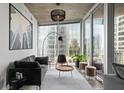 Well-lit living room featuring minimalist decor and city views at 155 S Court Ave # 1202, Orlando, FL 32801